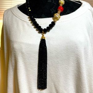 Handmade black bead necklace with cloisonné inspired accent.